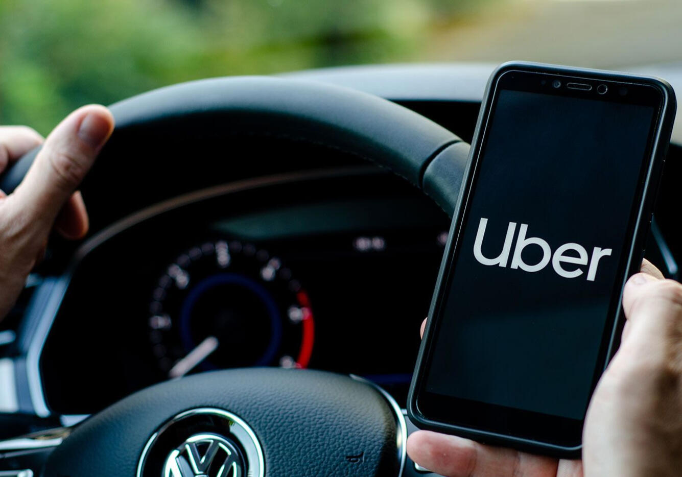 Uber app on phone in car